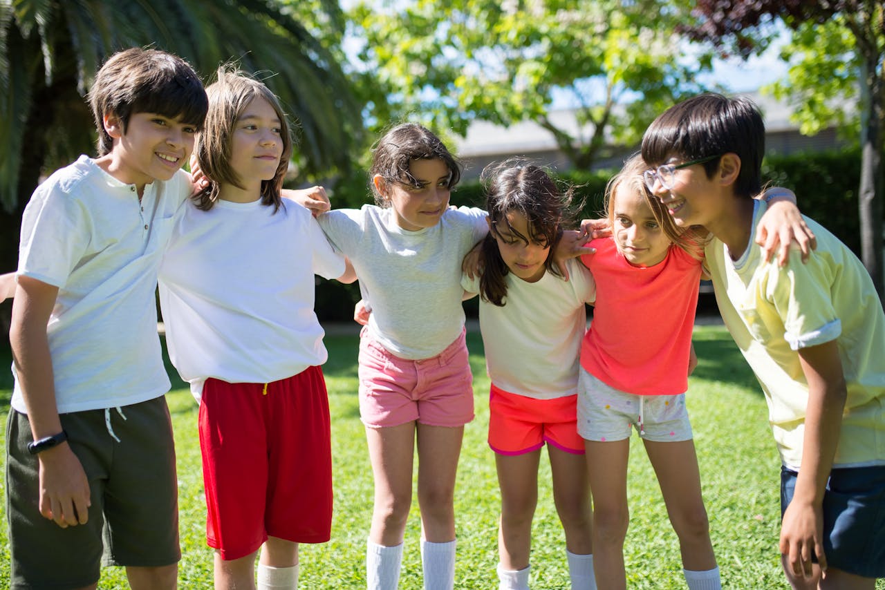 A joyful group of children playing outdoors, embodying friendship and happiness. Perfect lifestyle stock image.